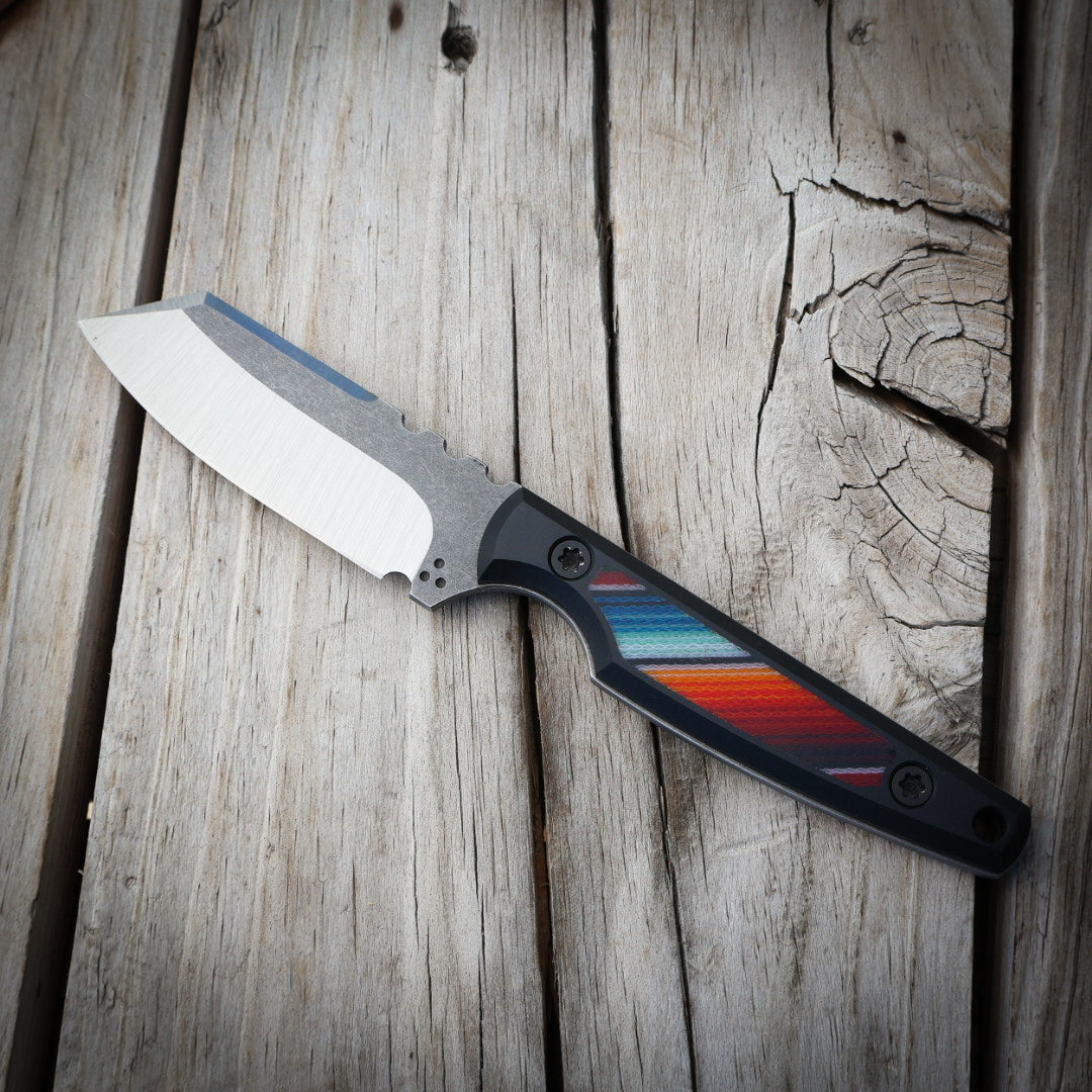 knife with a colorful handle on a wooden background