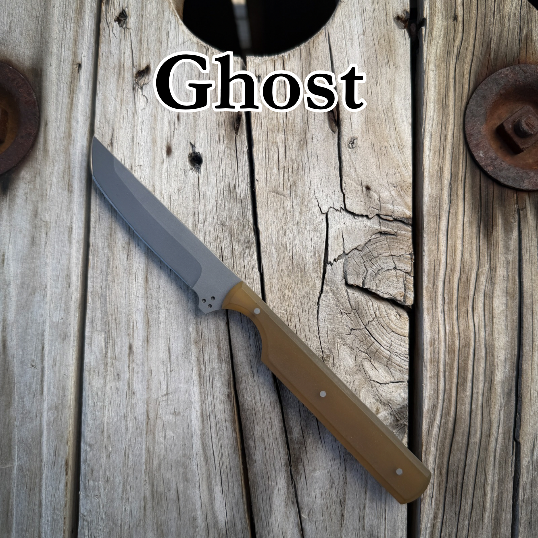Tanto styled knife with yellow ultem handle sitting on wooden surface. With the text “Ghost” above it 