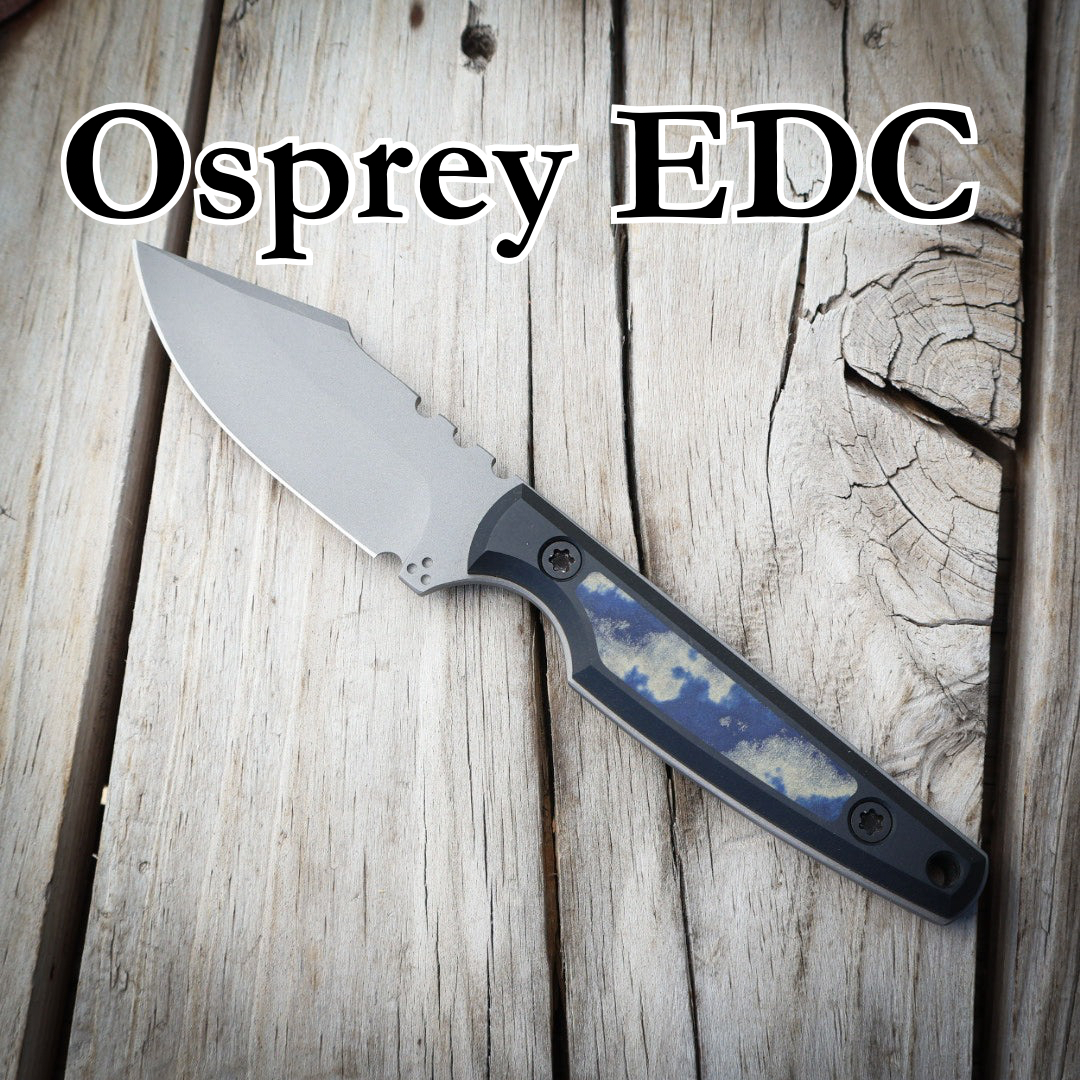 Fixed blade knife with blue and black handle sitting in wooden surface. Text “Osprey EDC” 