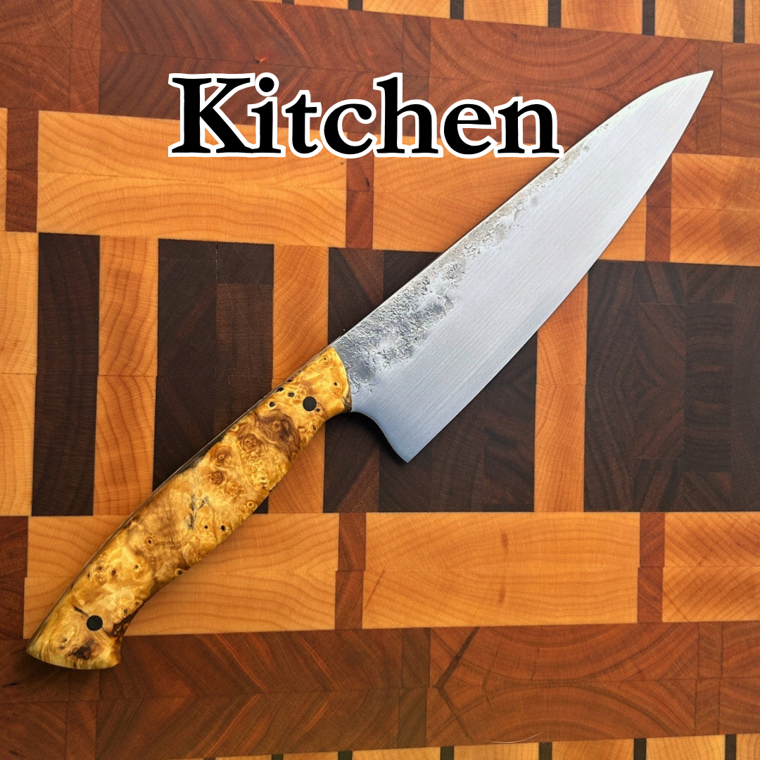 Kitchen knife with wooden handle sitting on wooden block surface. Text “kitchen”
