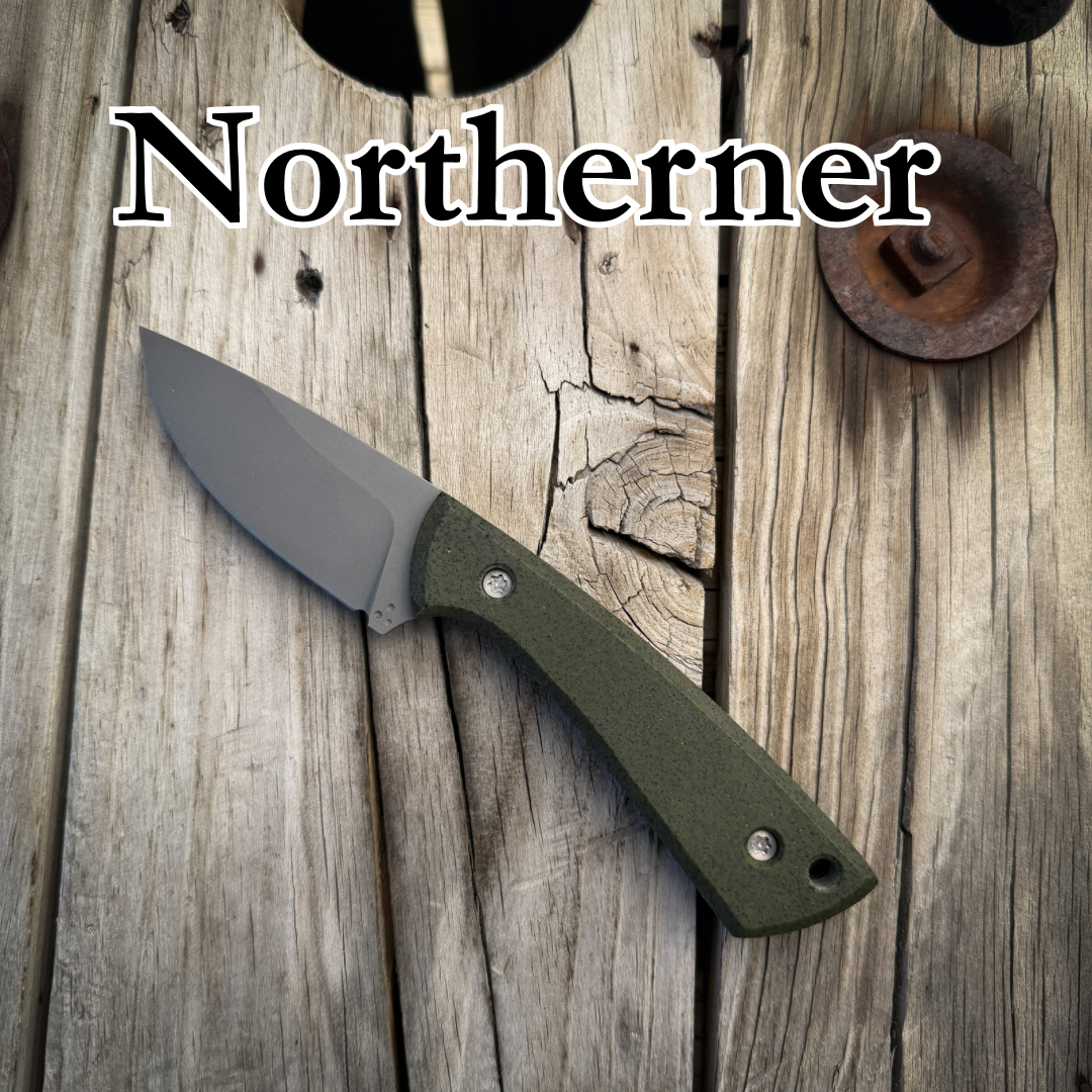 Drop point knife with green handle sitting on wooden surface. Text “Northerner” above it