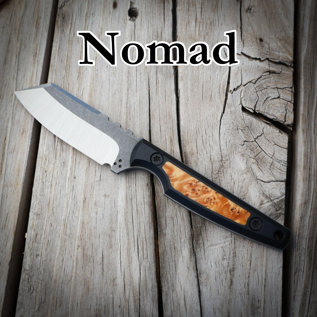 fixed blade knife sitting on wooden surface. With text “Nomad”