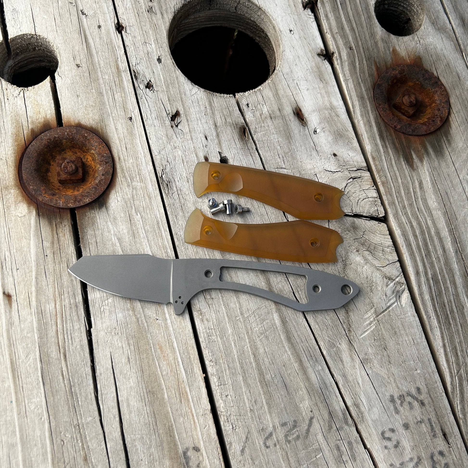 Knife with amber colored ultem scales removed. Showing the skeletonized tang of the knife