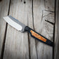 knife with wood inlay in black handle sitting on wooden surface 