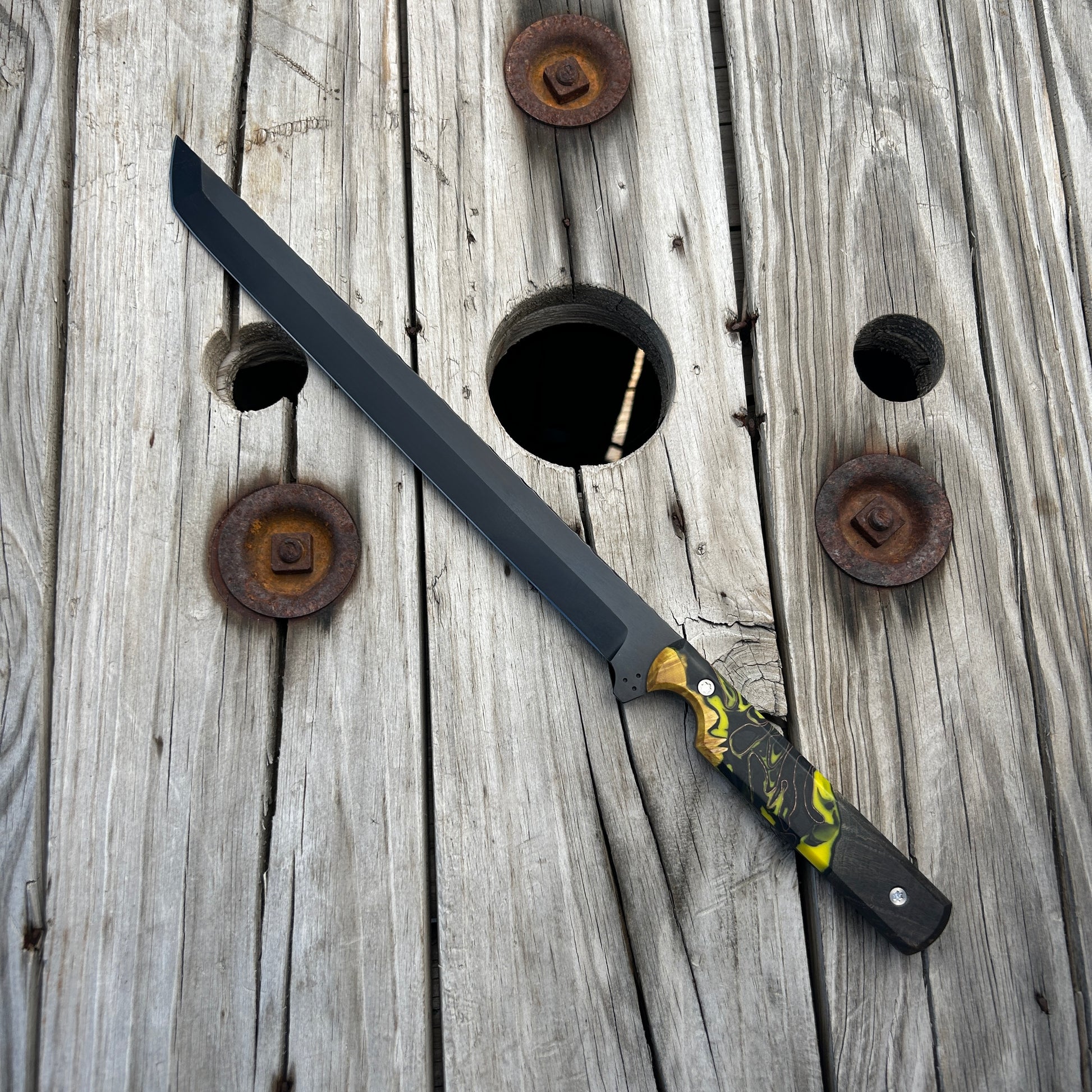 long sword with a detailed handle on a wooden background