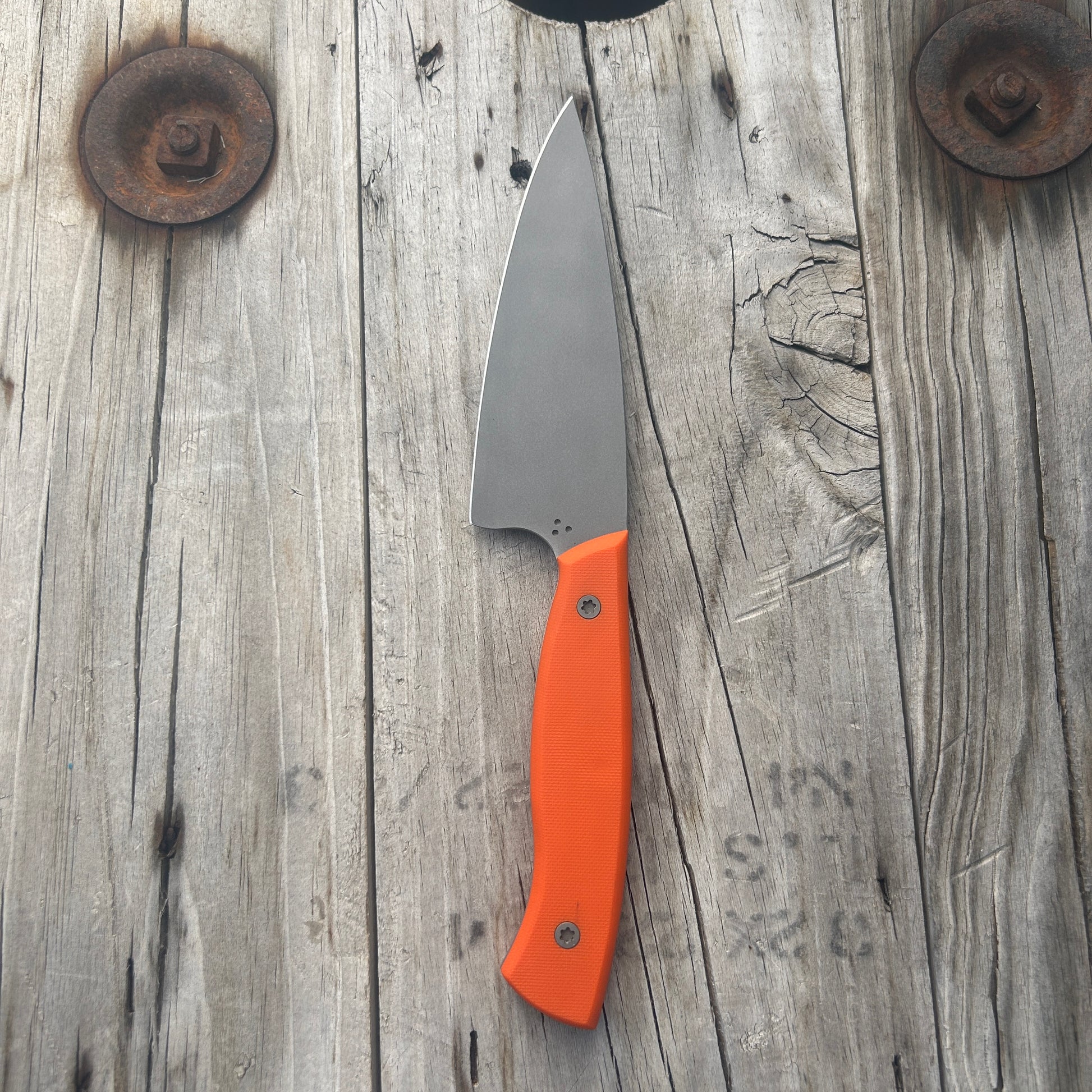 Petty chef knife with orange colored handle