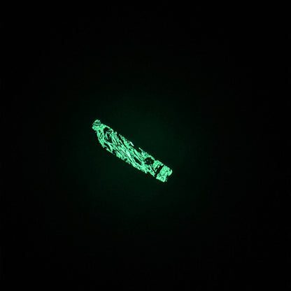 Glow in the dark inlay on knife handle. Glowing green with specs of black in the middle 