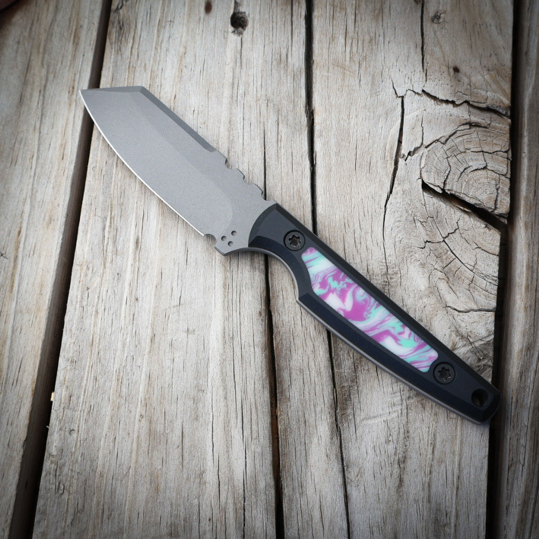Knife with a colorful handle on a wooden surface