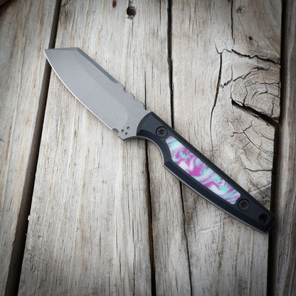 Knife with a colorful handle on a wooden surface