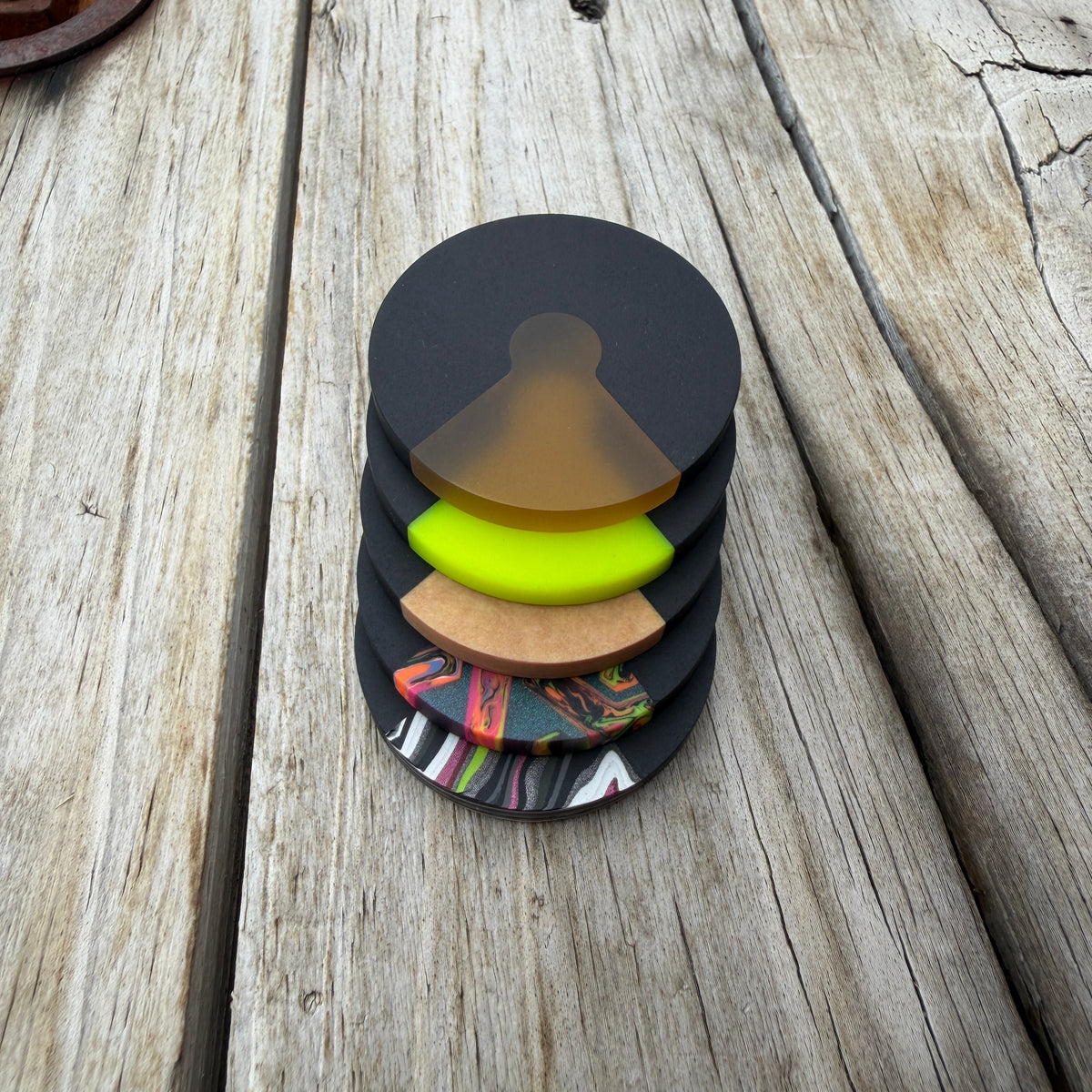 Stack of edc coins sitting on wooden surface 
