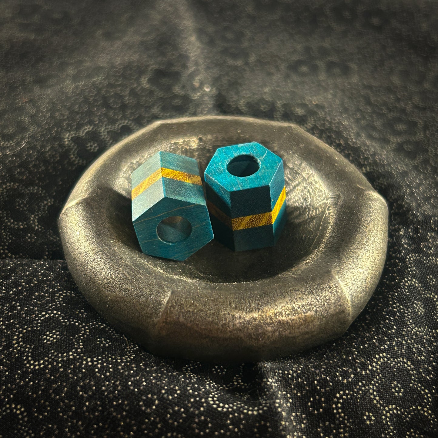 Blue and yellow hexagonal lanyard beads in metal dish 