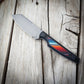 Knife with a colorful handle on a wooden surface