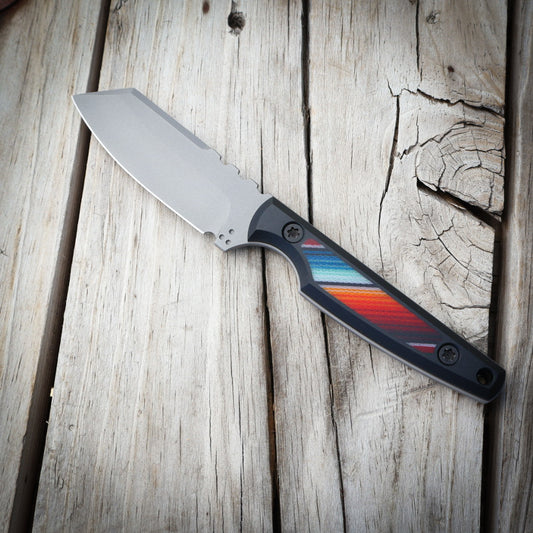 Knife with a colorful handle on a wooden surface