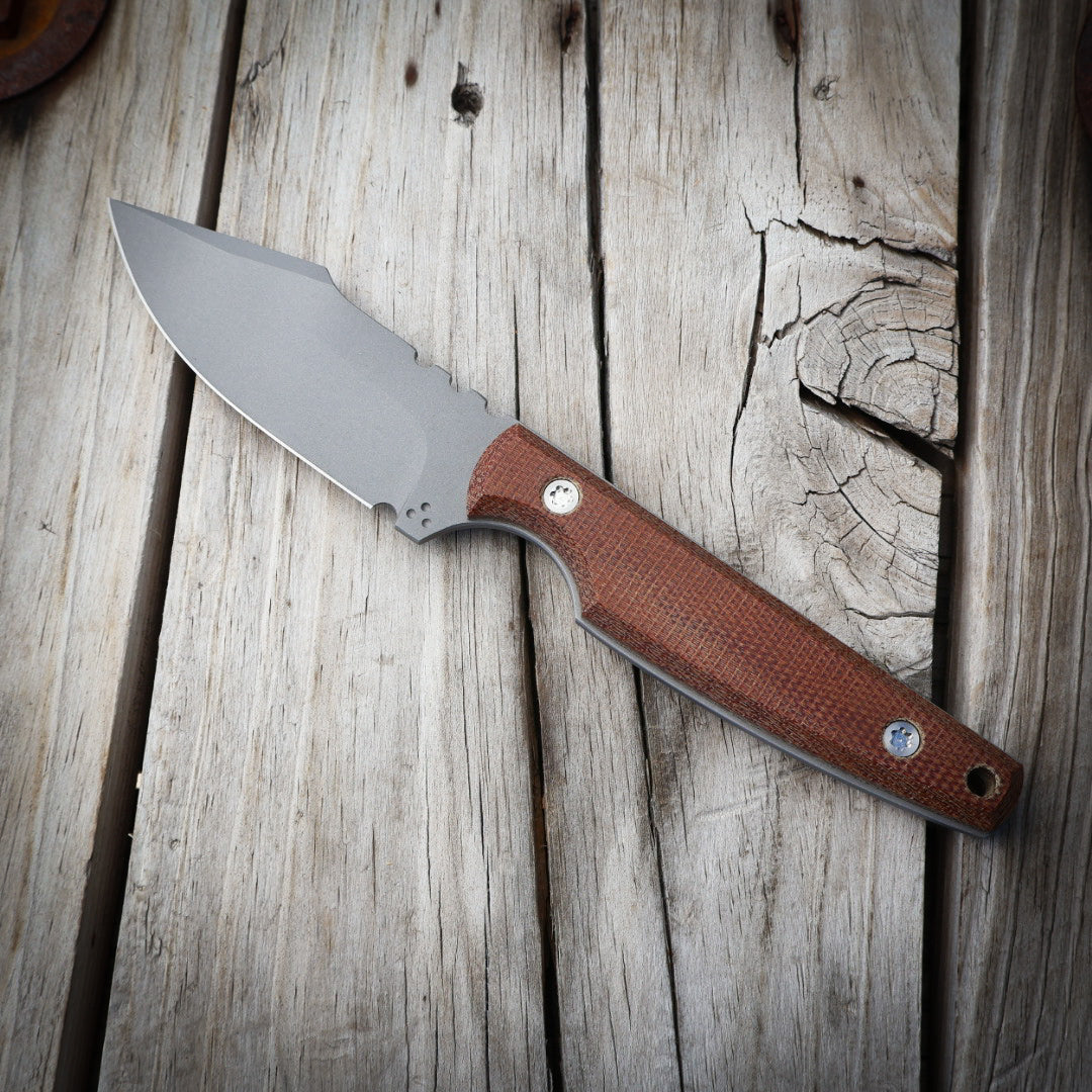 Knife with a brown handle on a wooden surface
