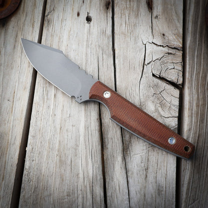 Knife with a brown handle on a wooden surface