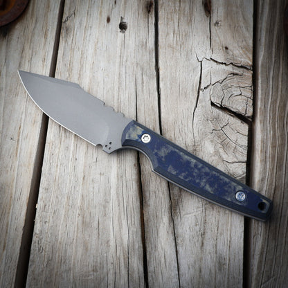 knife with blue handle on wooden surface