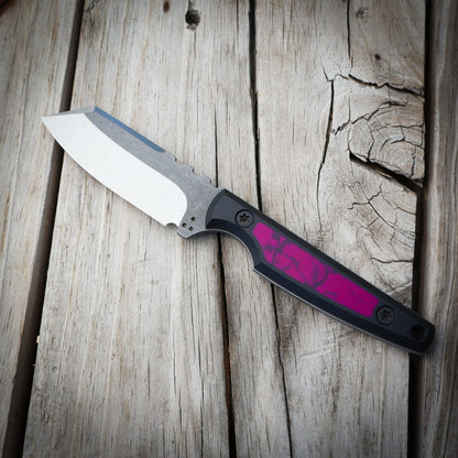 Knife with a purple handle on a wooden surface