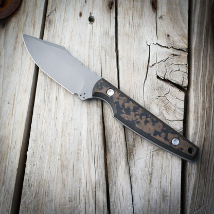 Knife with brown & black handle on wooden surface