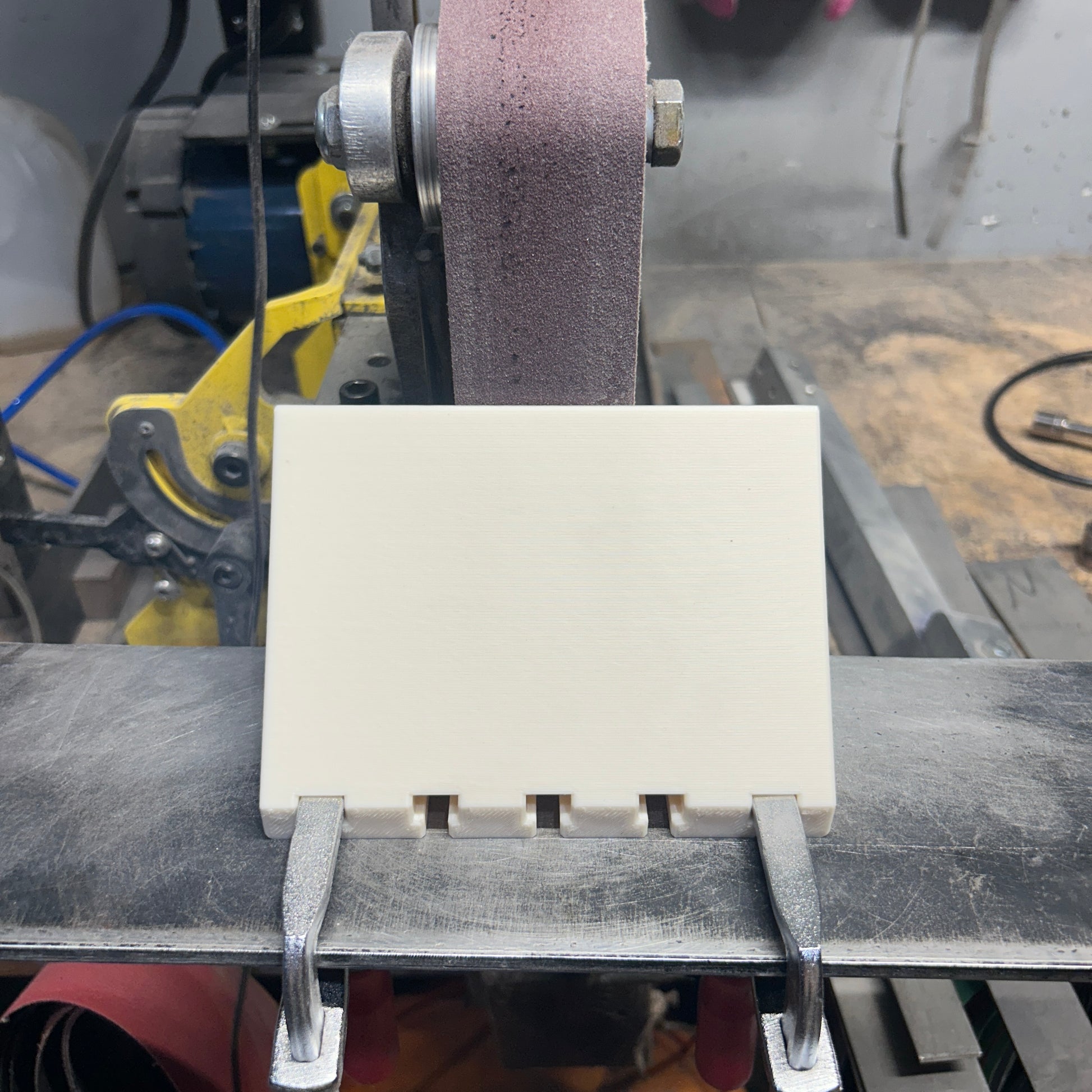 Chamfer jig clamped to grinder work rest