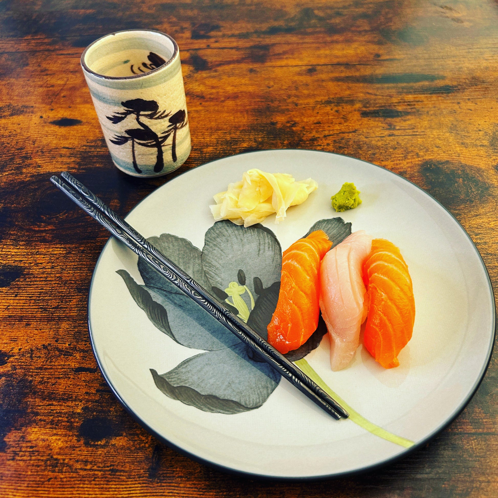 damascus chopsticks on plate with sushi