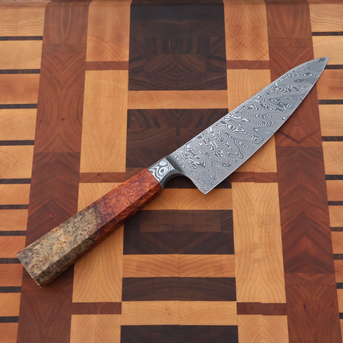 Decorative chef's knife with a wooden handle on a wooden cutting board