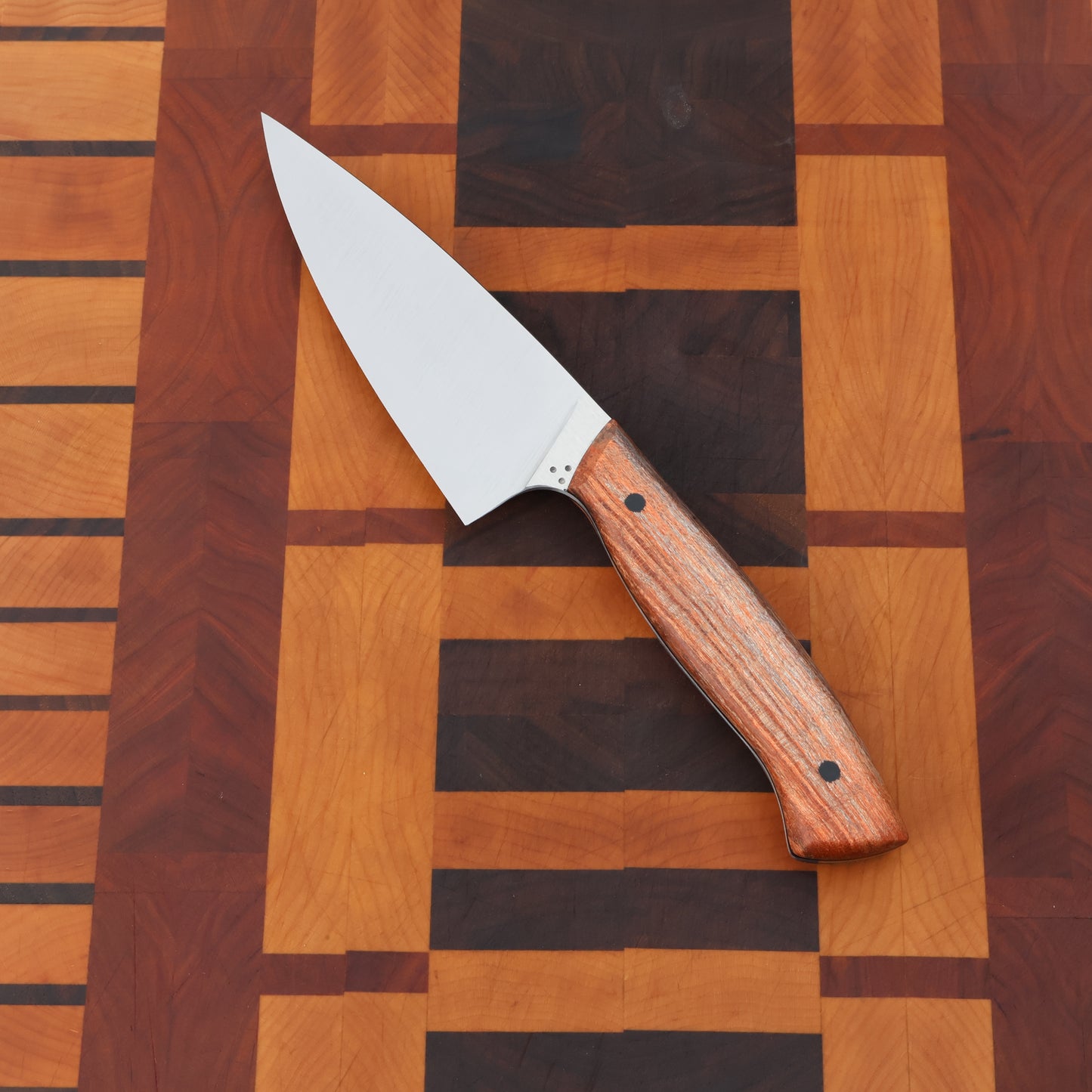 Petty chef kitchen knife with wood handle scales