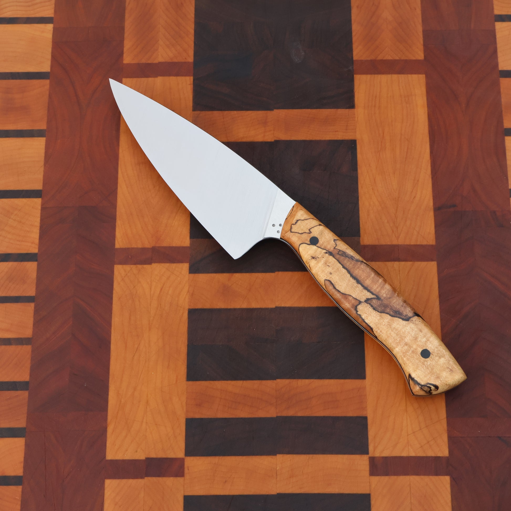Petty chef kitchen knife with wood handle scales