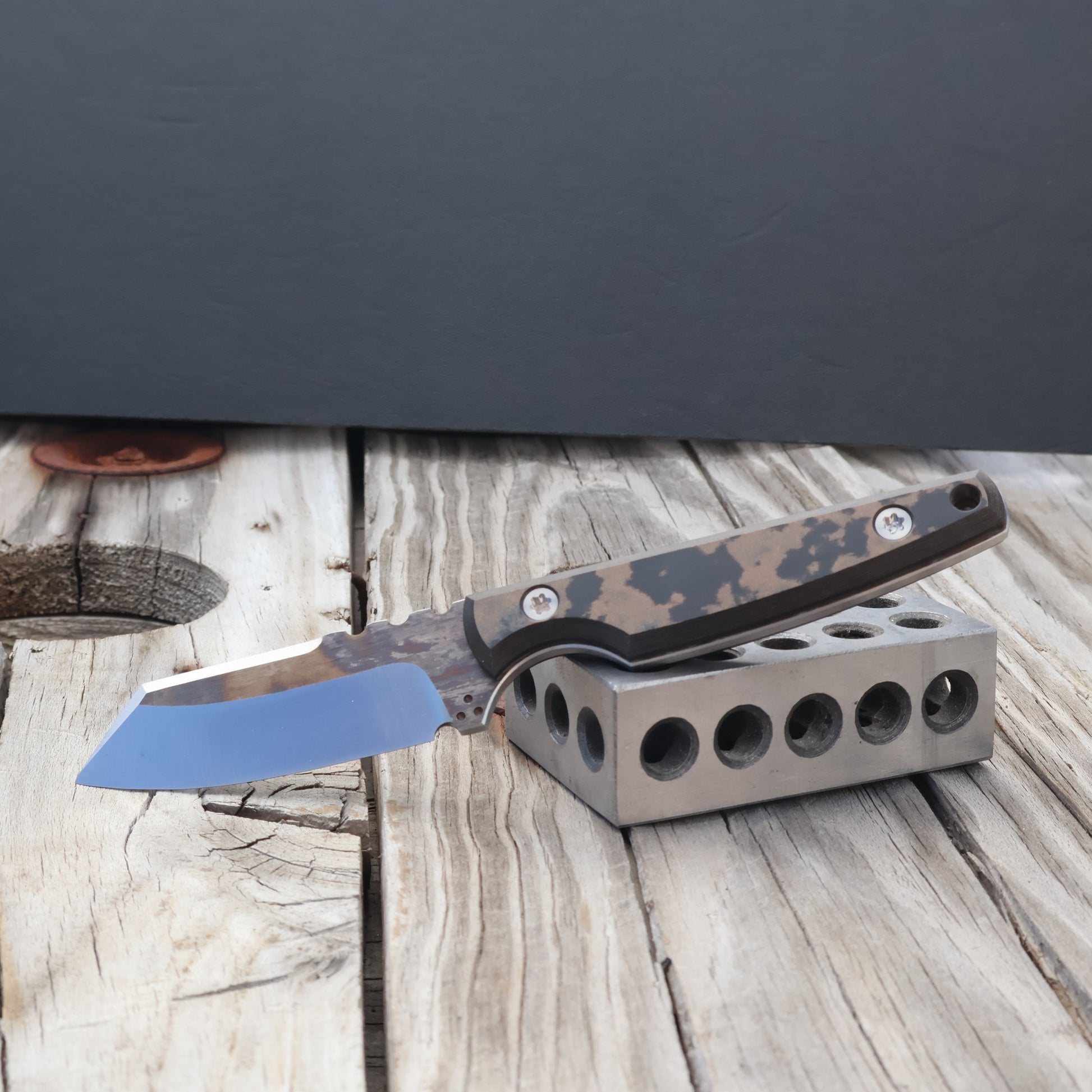 Fixed blade knife with two tone bevels and black and brown camo style richlite handles
