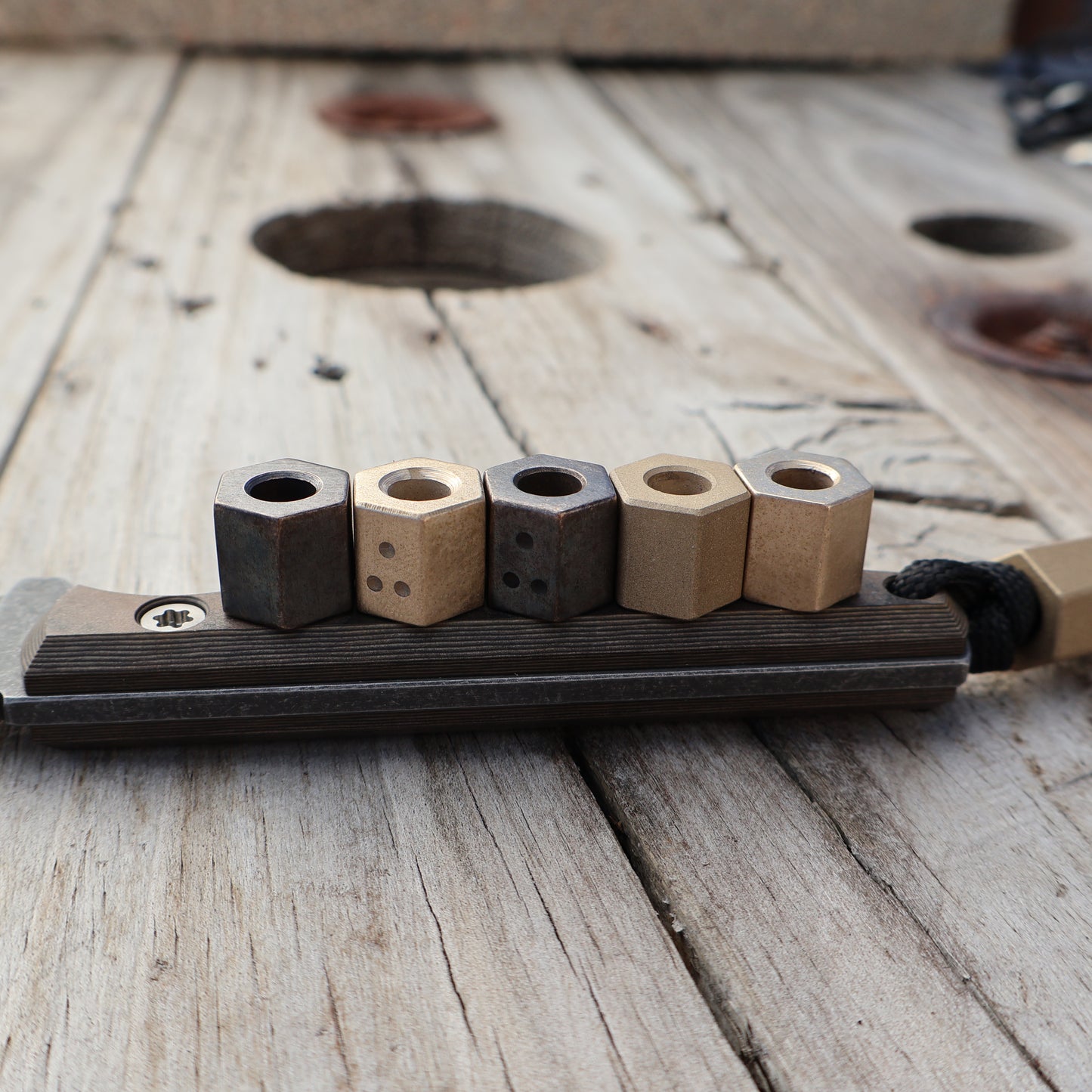 Hexagonal Brass Beads sitting on knife handle 