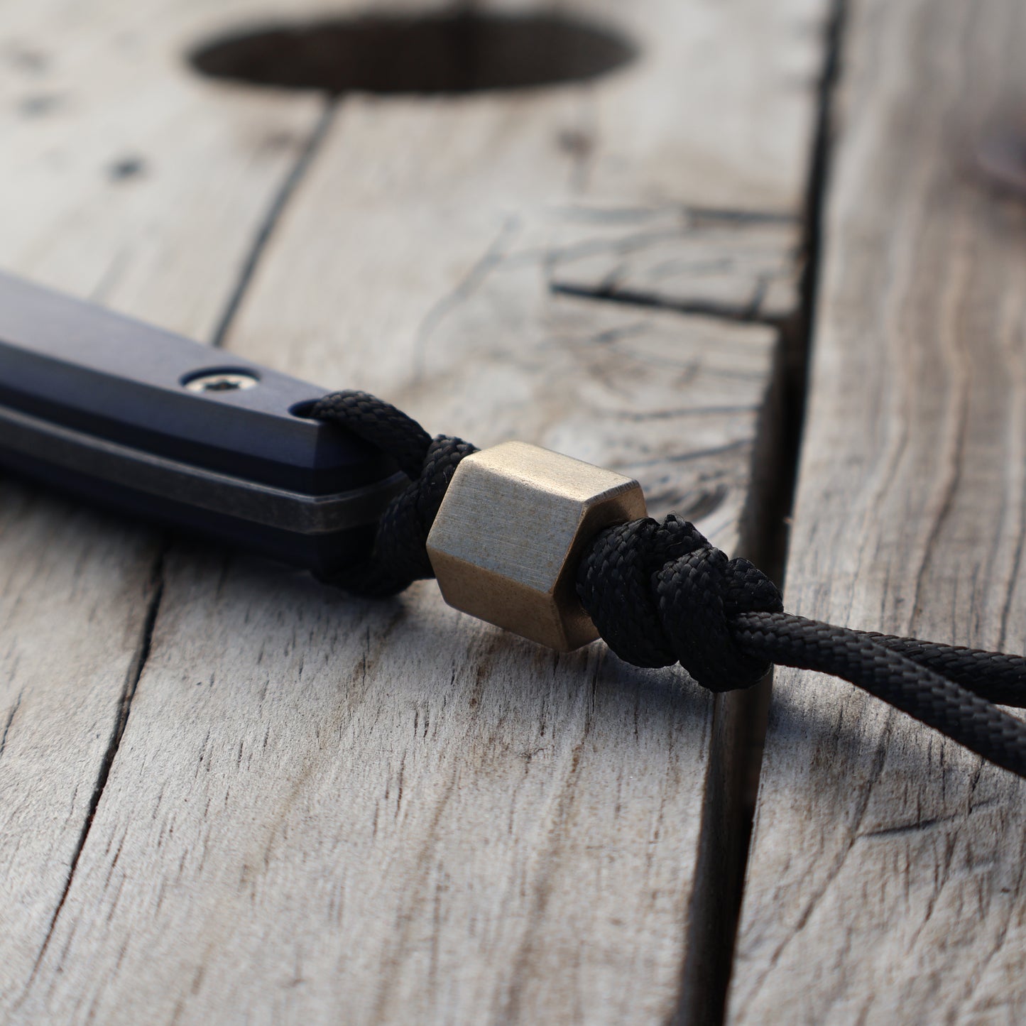 Hexagonal brass bead on knife lanyard