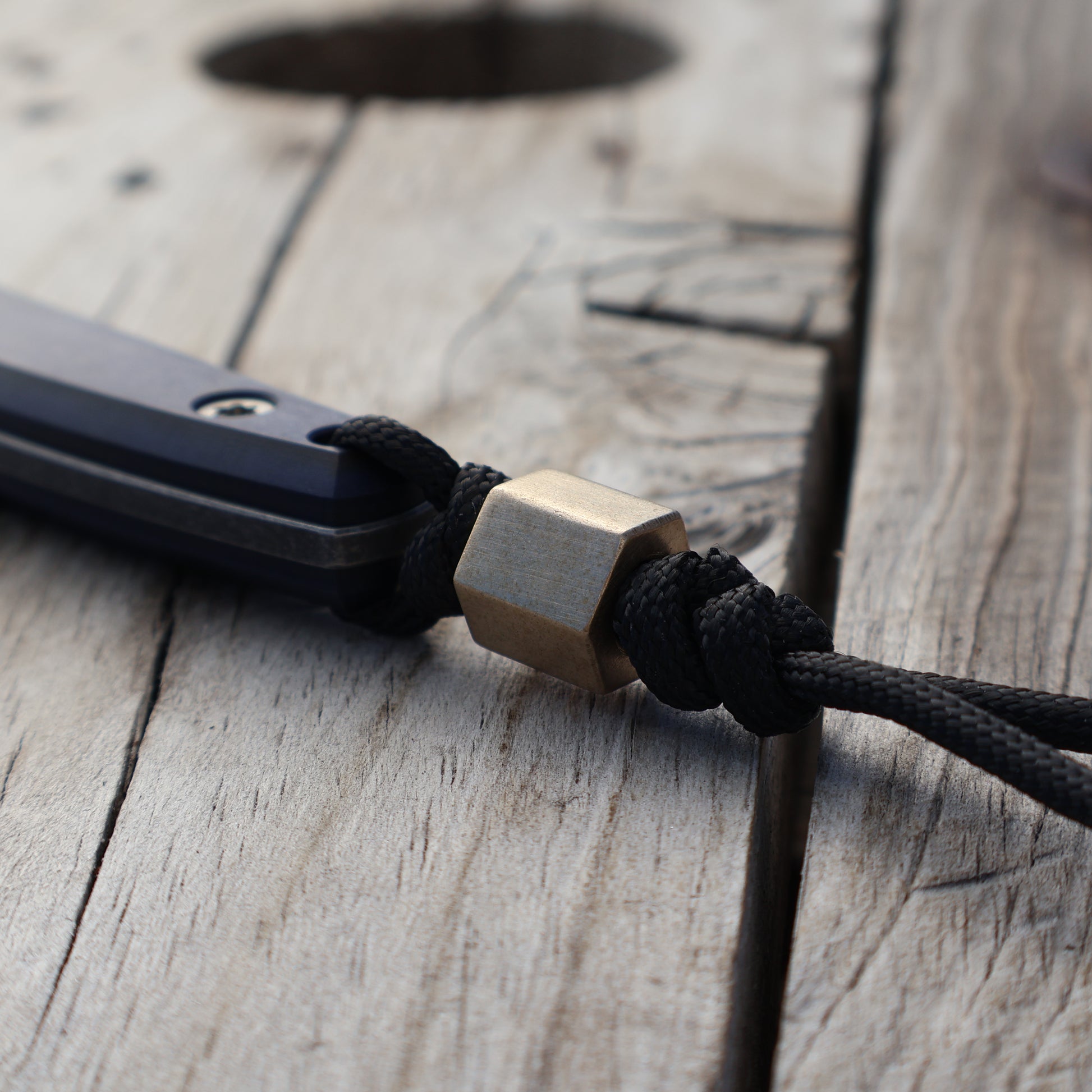 Hexagonal brass bead on knife lanyard