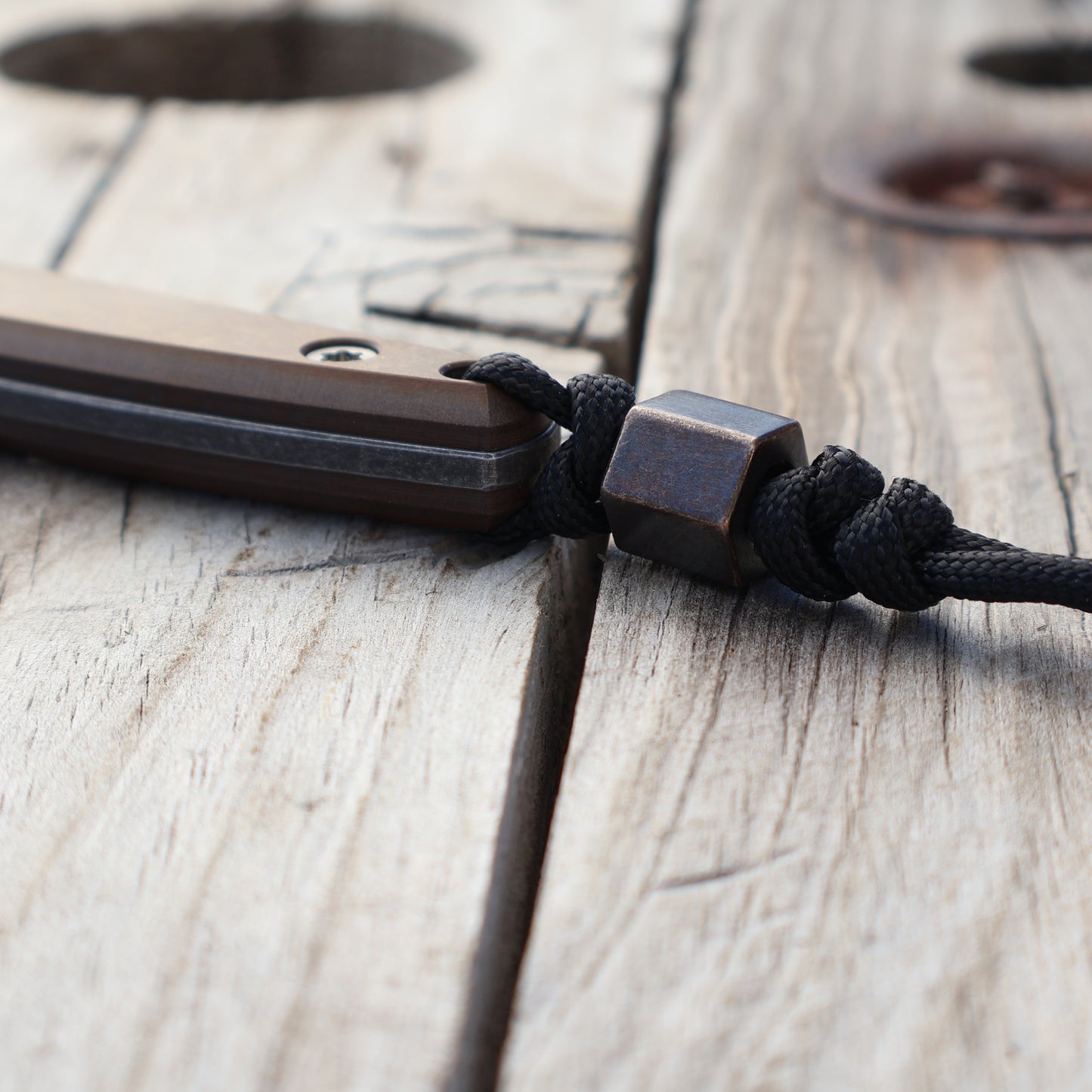 Blackened hexagonal brass bead on knife lanyard 