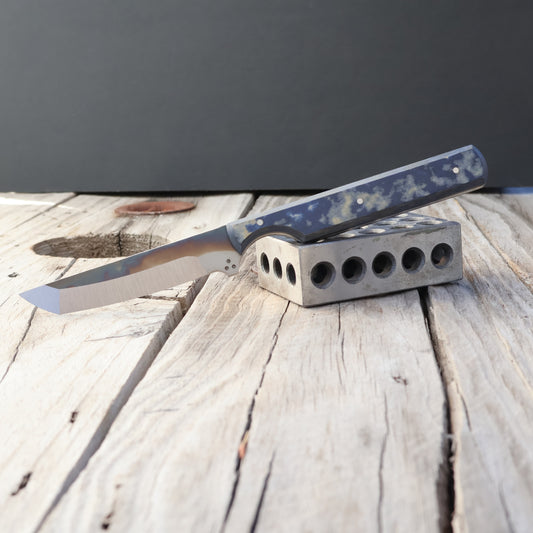 Knife with a micarta handle on a wooden surface