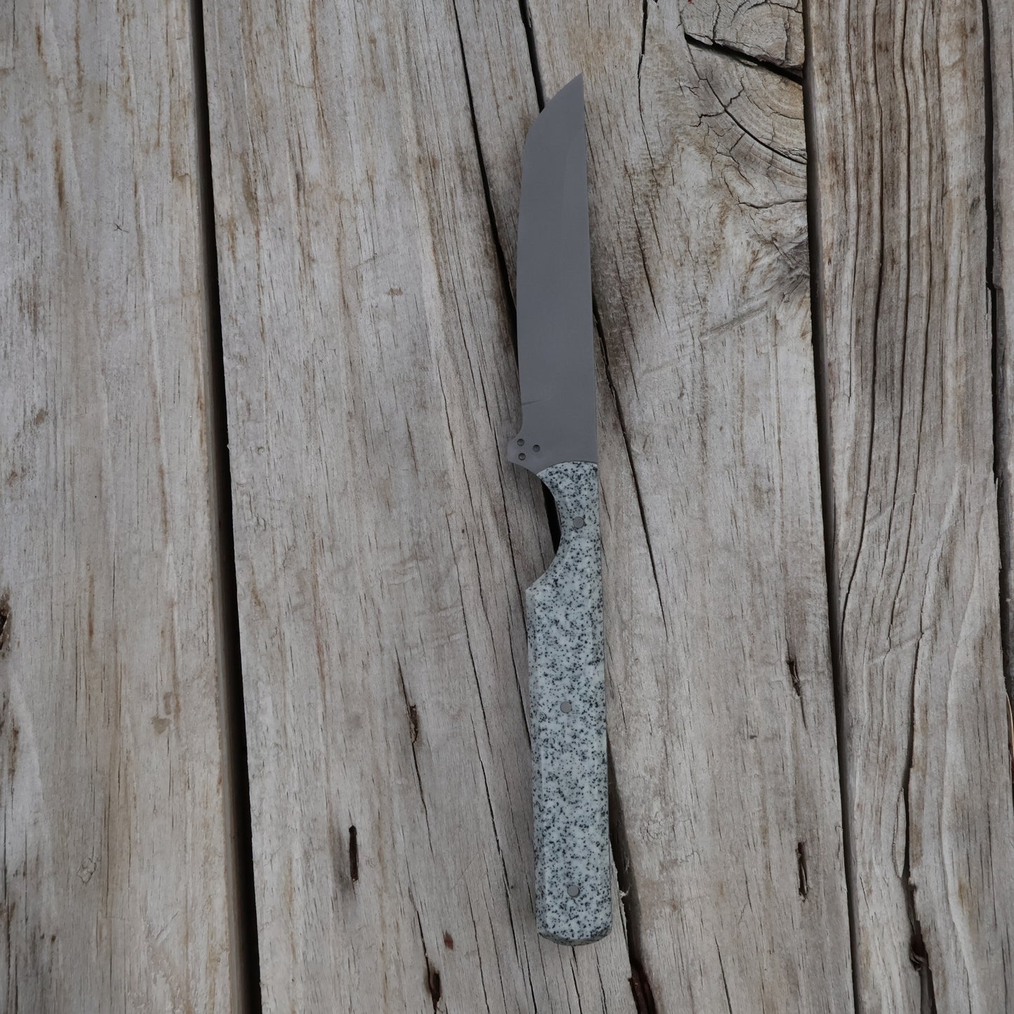 Knife with a textured handle on a wooden surface