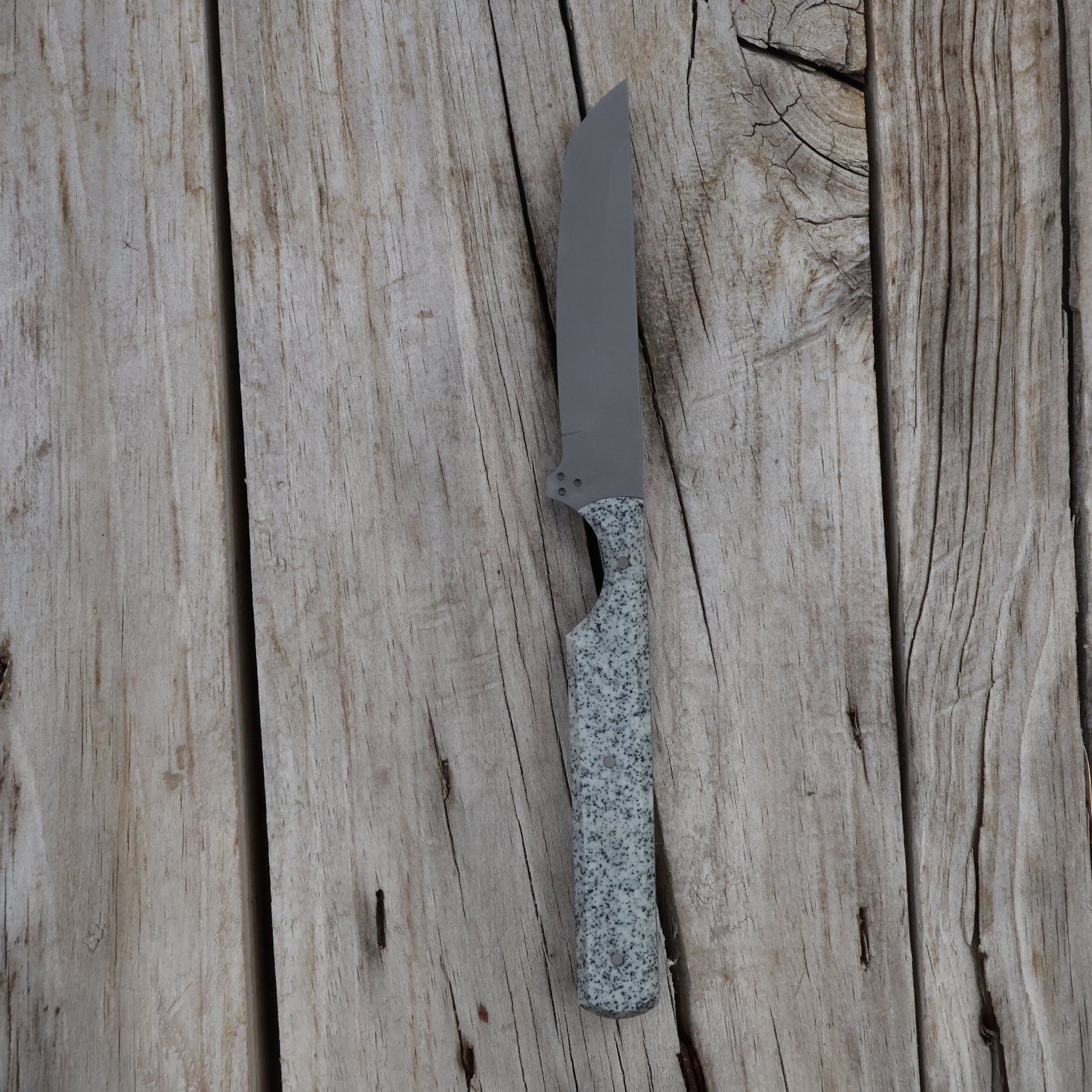 Knife with a textured handle on a wooden surface