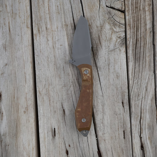 Knife with a brown handle on a wooden surface