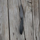 Knife with a black handle on a wooden surface