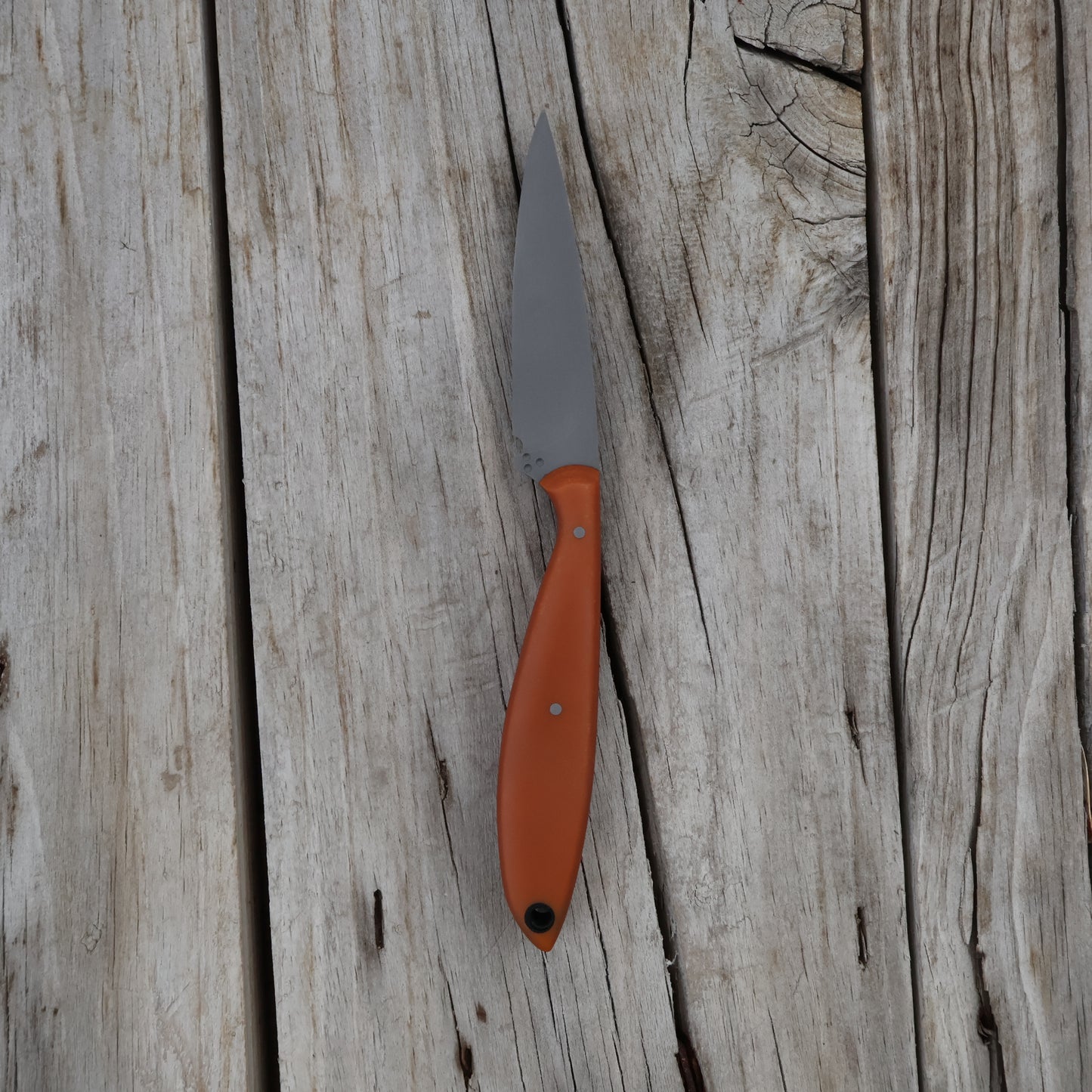 butterscotch-handled knife on a wooden surface