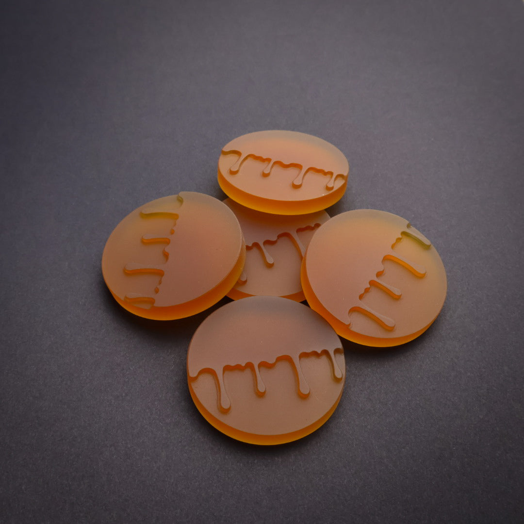Five amber decorative coins 