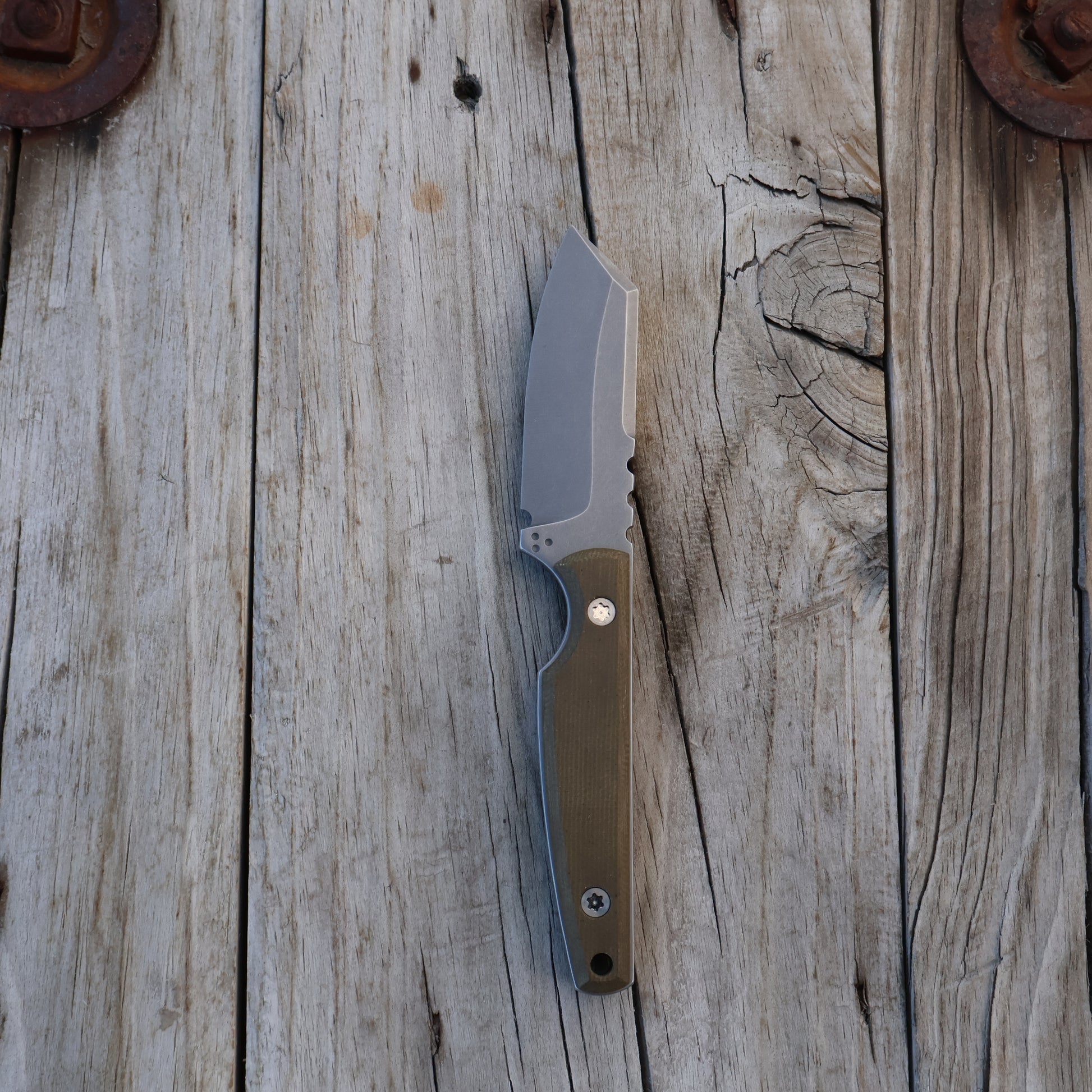 fixed blade knife on a wooden surface