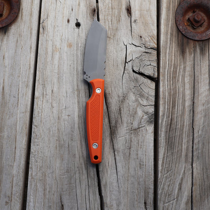 Knife with a textured orange handle on wooden surface 