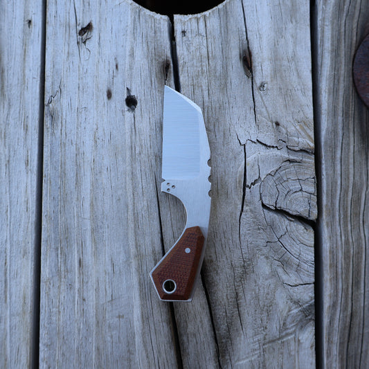 Knife with a brown handle on a wooden surface