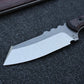 Closeup of knife blade, knife sitting on black foam surface