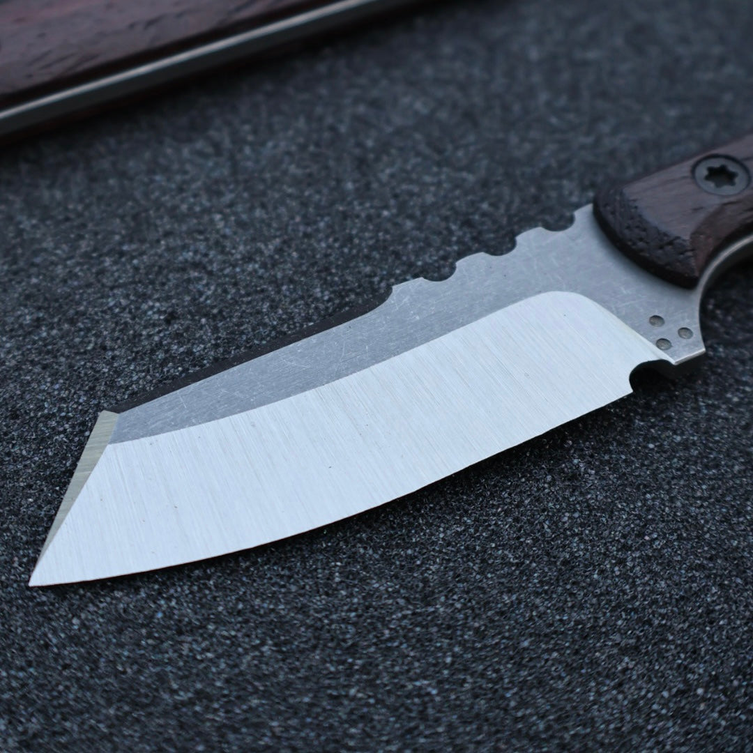 Closeup of knife blade, knife sitting on black foam surface