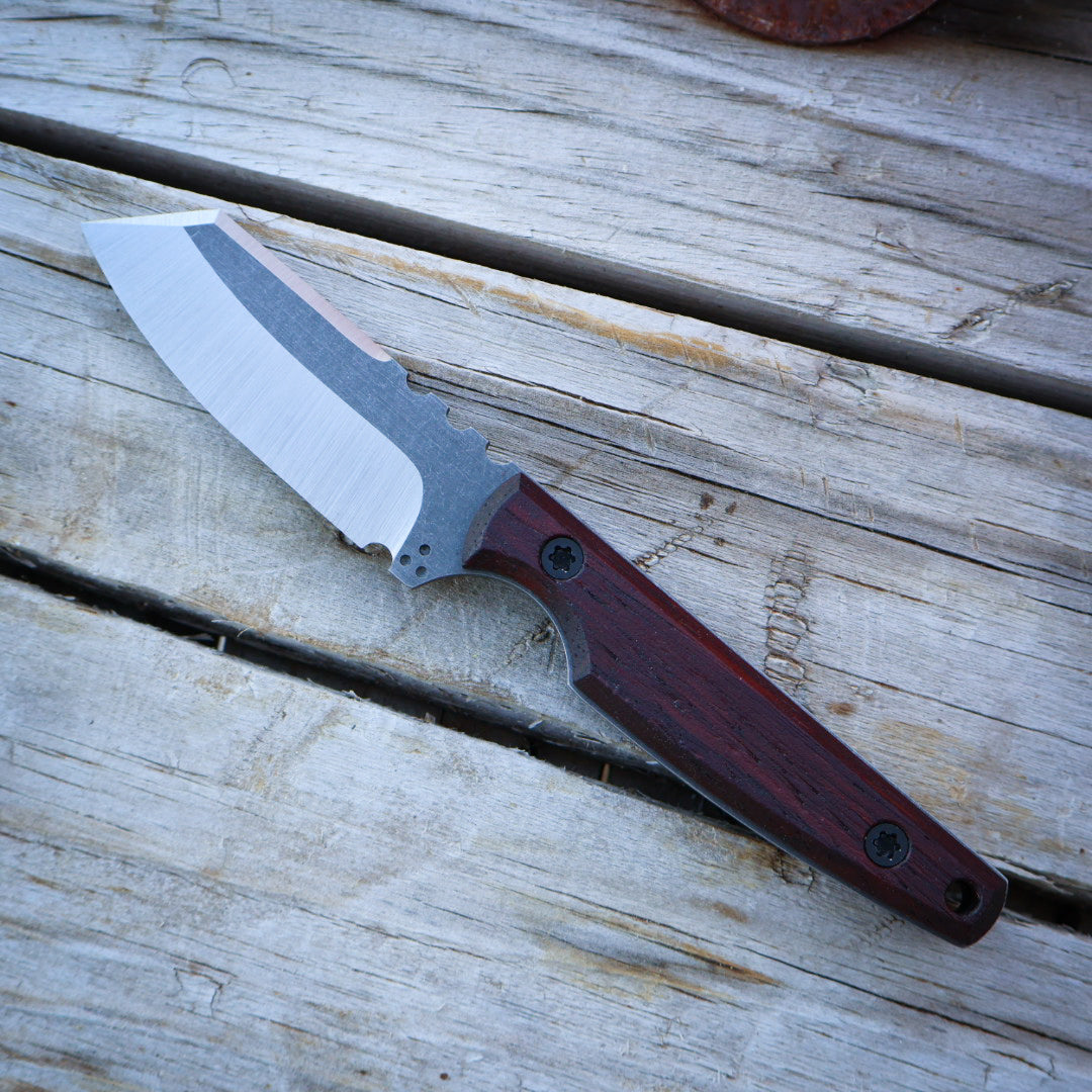 Knife with a wooden handle on a wooden surface
