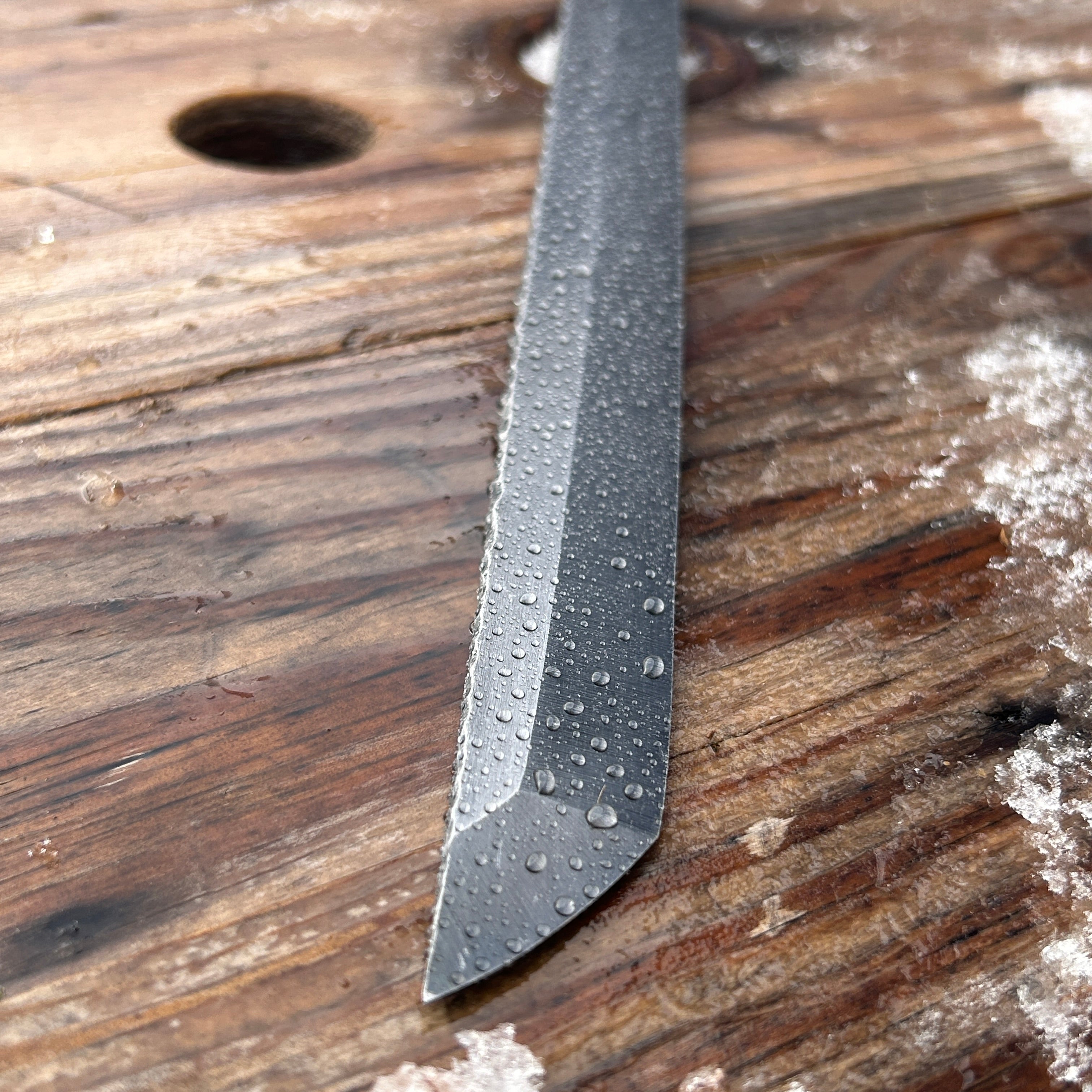 close up of water droplets on a knife blade 