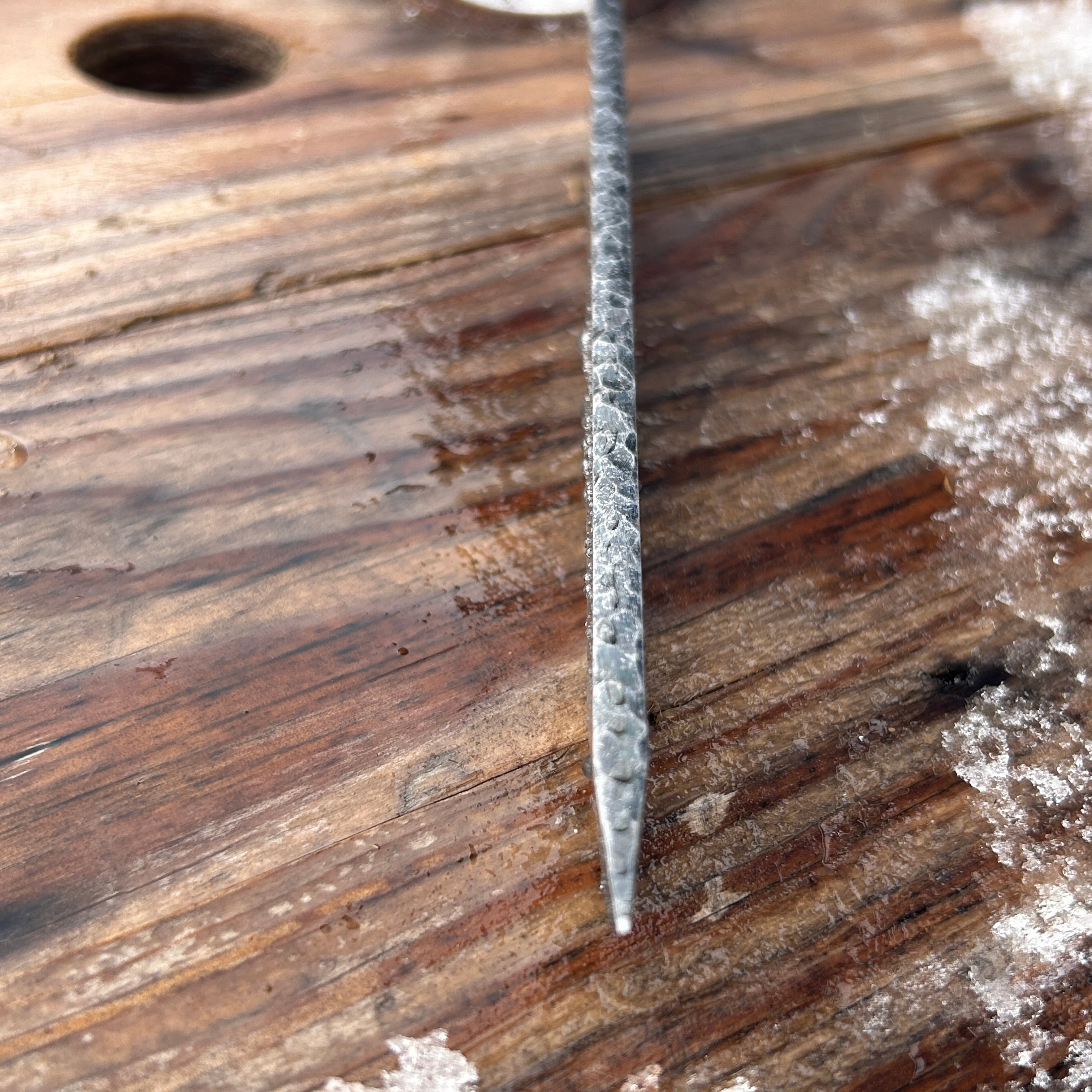 Close up of rock texturing on spine of sword. 