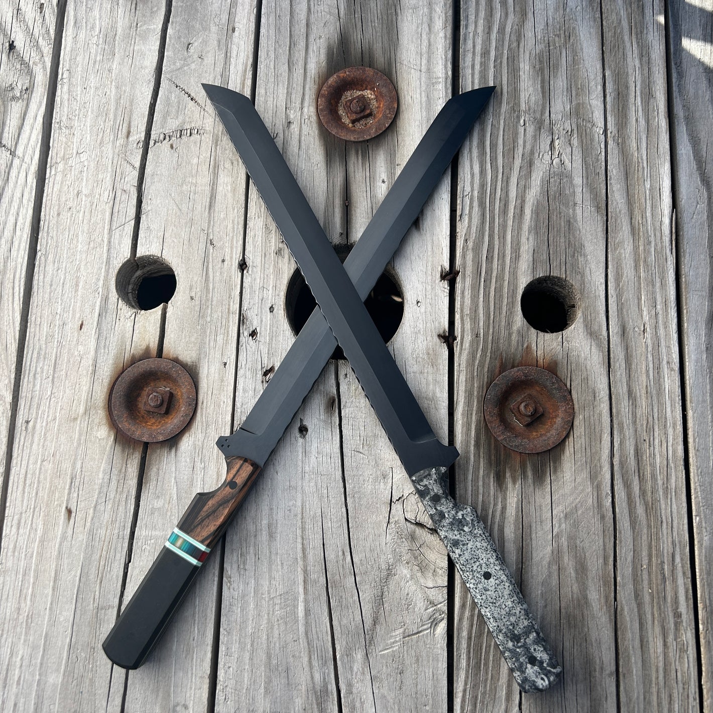 Two crossed swords on a wooden surface with rusty nails.