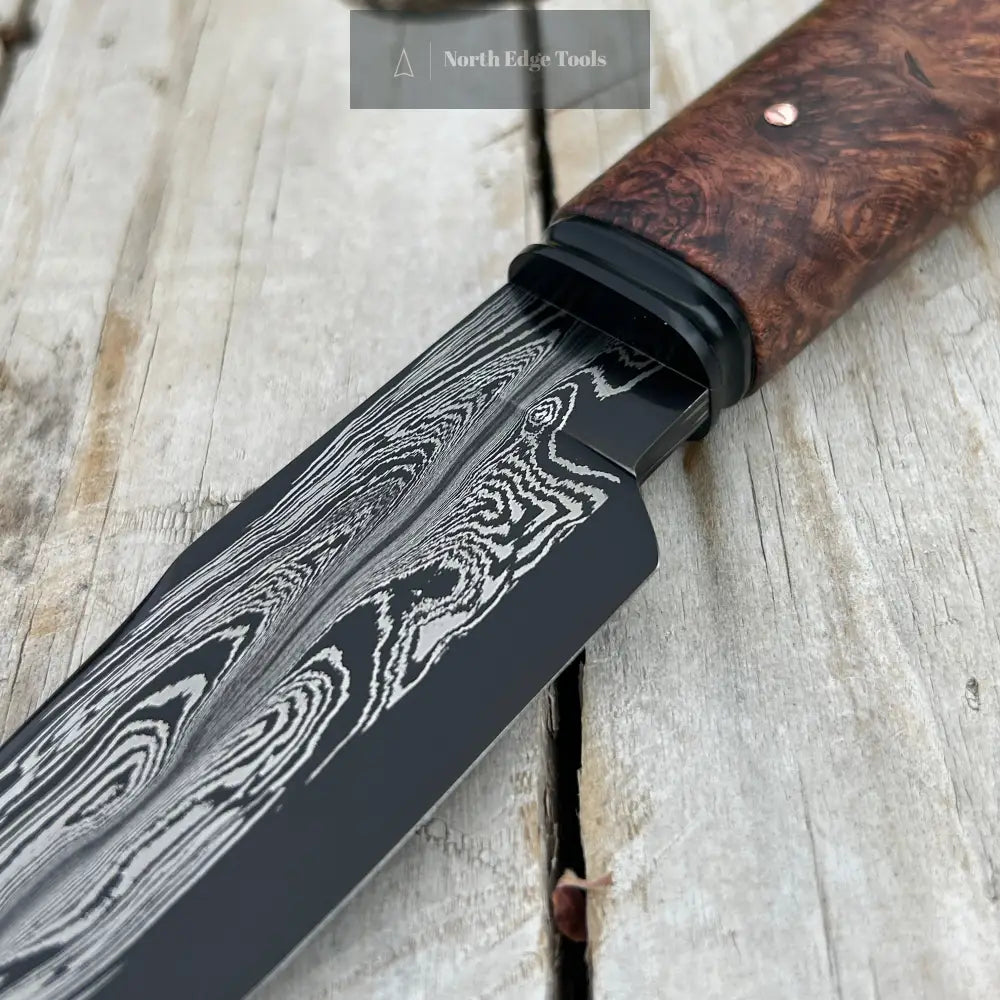 closeup of damscus blade and black fluted bolster