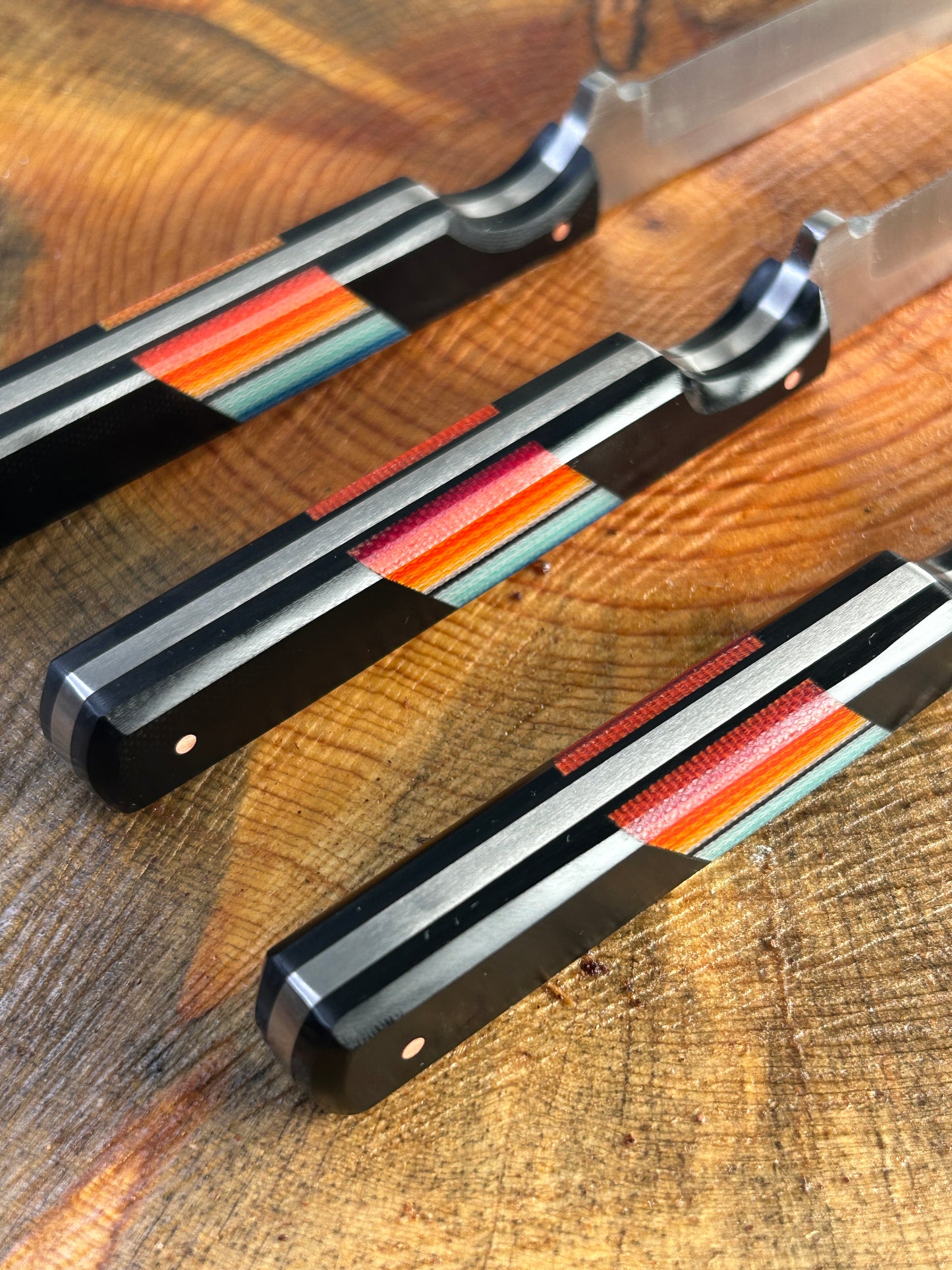 closeup of three black, blue & red serape handles